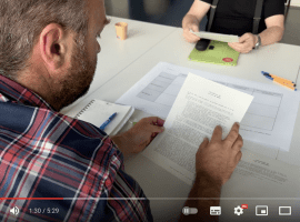 A man reading a document during one of the workshop on Rudi's governance model